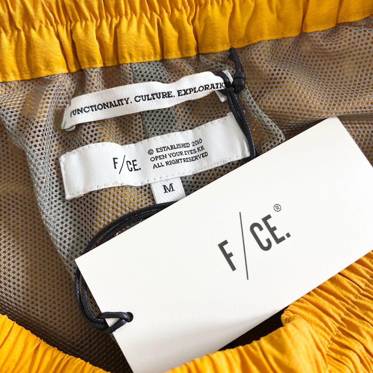 48C13 F/CE. エフシーイー RECYCLE TECH TRACK PANTS テック素材 トラックパンツ M オレンジ メンズ RSU0323M0001