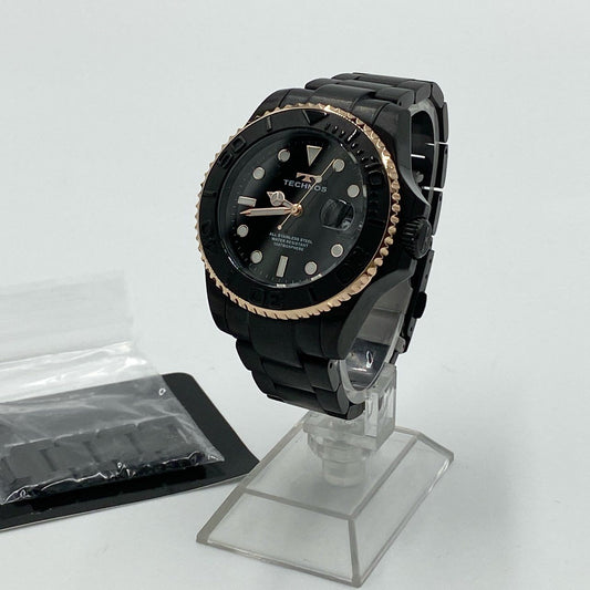 h21《美品》 TECHNOS テクノス 100周年記念モデル メンズ腕時計 T9C29 ブラック ゴールド コマ有 日付表示 逆回転防止ベゼル クリスタルガラスt18r
